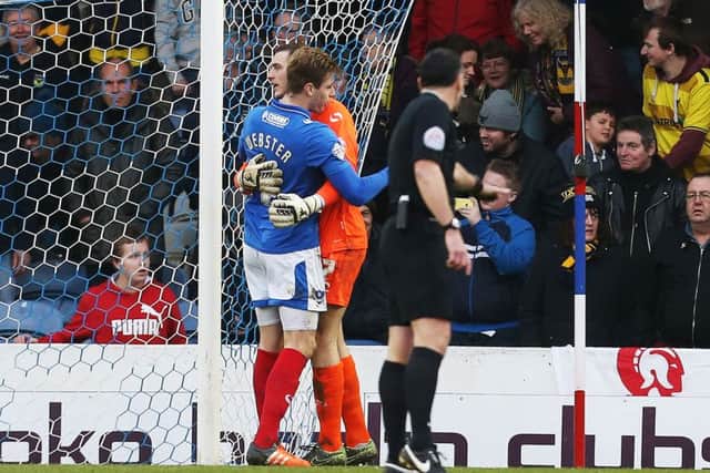Ryan Fulton gets a hug from Adam Webster after saving the penalty. Picture: Joe Pepler