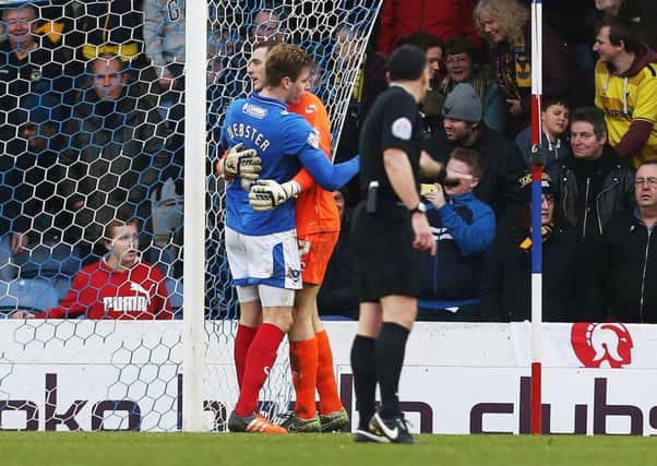 Ryan Fulton gets a hug from Adam Webster after saving the penalty. Picture: Joe Pepler