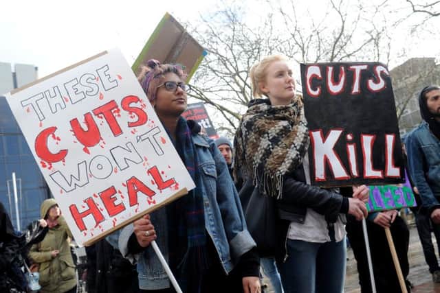 A protest held in Portsmouth in December against the city council's planned cuts to domestic abuse services