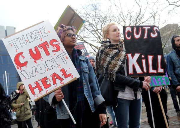 A protest held in Portsmouth in December against the city council's planned cuts to domestic abuse services