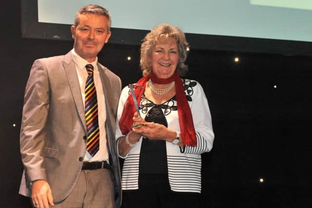Simon Barrable, the deputy principal of sponsors Portsmouth College, presents the Special Achievement Award to Audrey Pring at the WOW247 Awards at The Kings Theatre, Southsea.Picture: Allan Hutchings (160146-352)