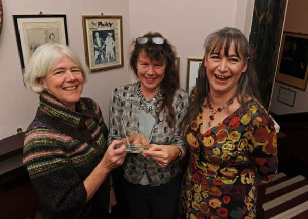Jane Mee, Deborah Richards, and Katy Ball from Portsmouth's museum service, collecting the award for best exhibition