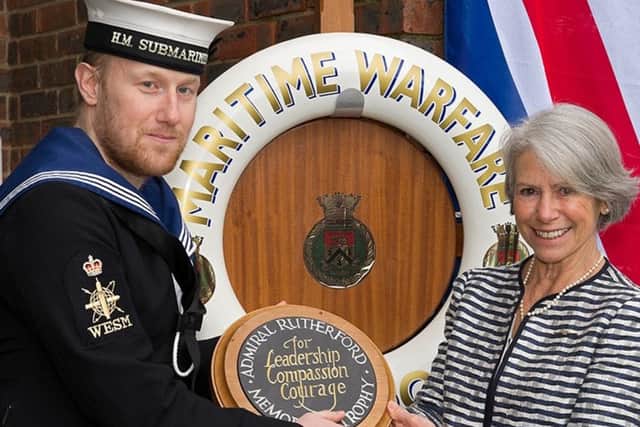 Leading Engineer Technician Weapon Engineer Submariner Luke Dineen-Willis receiving his trophy from Lady Fleur Boyce