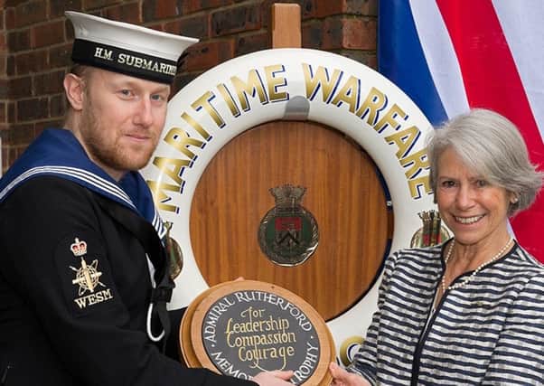 Leading Engineer Technician Weapon Engineer Submariner Luke Dineen-Willis receiving his trophy from Lady Fleur Boyce