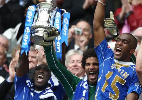 Slyvain Distin, right, celebrates winning the FA Cup in 2008