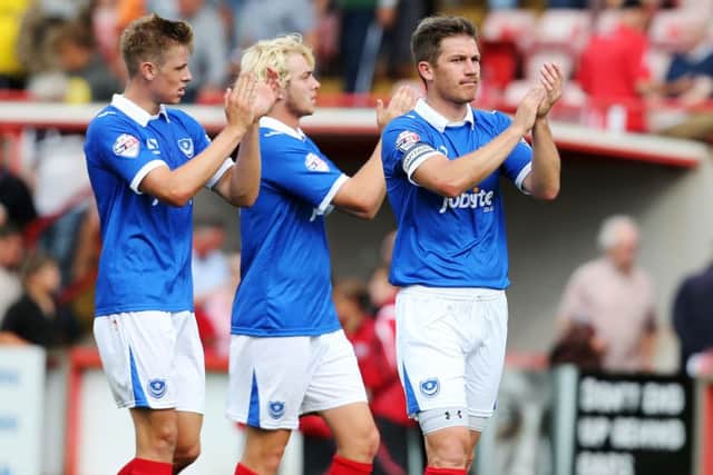 Adam Webster, left, Jack Whatmough and former Blues defender Ben Chorley applaud the Pompey fans at Exeter in August, 2014. Picture: Joe Pepler