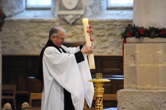 The Very Reverend David Brindley, The Dean of Portsmouth who led the service replaces The Paschal Candle after it was lit
Picture: Malcolm Wells (160126-5621)