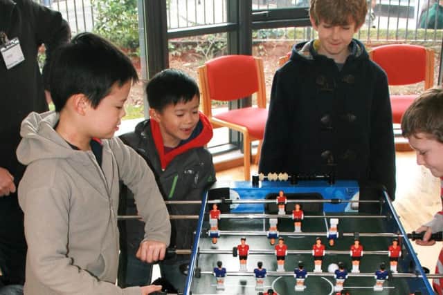 FAMILIES Children enjoying the table football at Funday Sunday at St Judes Church, Southsea