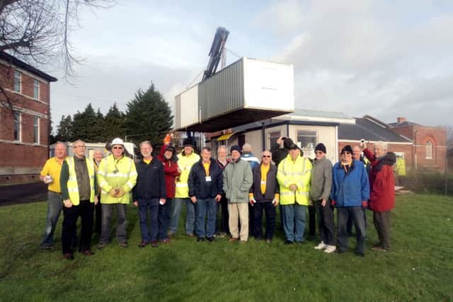 Members of the Gosport Men's Shed with their new cabin at St Vincent College