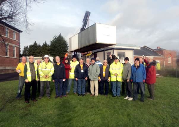 Members of the Gosport Men's Shed with their new cabin at St Vincent College
