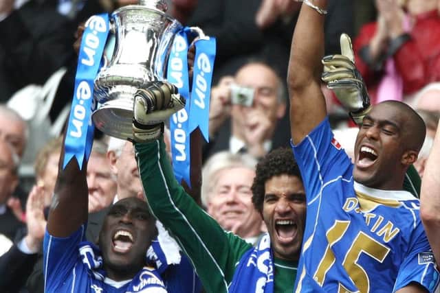 Sol Campebll lifts the FA Cup along with David James and Sylvain Distin