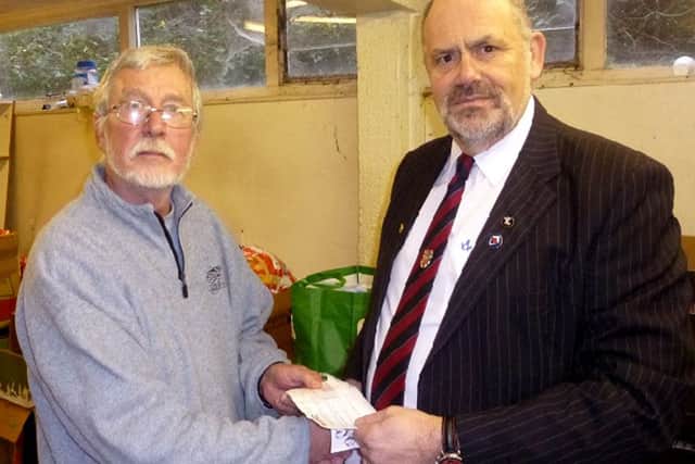 Prince of Wales Lodge member David Andrews presents a cheque for £400 to Clive Erricker at the Gosport Basics Food Bank