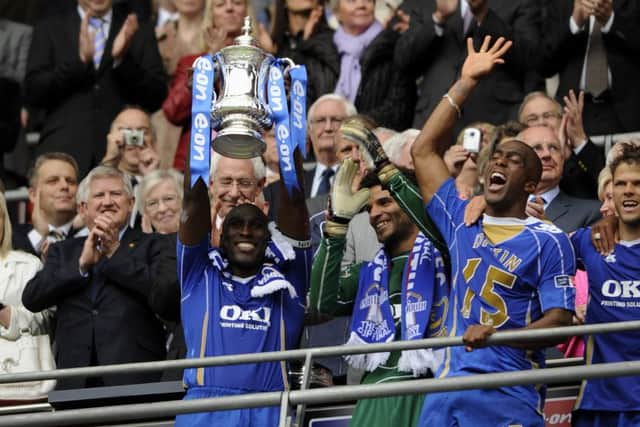 Sylvain Distin celebrates lifting the FA Cup with Pompey