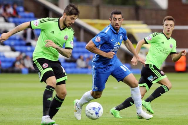 Kieron Freeman, left, in action against Peterborough this season Picture: Joe Dent