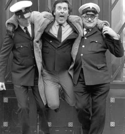 Security men pretending to frogmarch Sir Terry Wogan from Broadcasting House in London as a humourous finale to his 12 years hosting the early morning BBC 2 radio breakfast programme. The veteran broadcaster has died aged 77 following a short illness. Photo: PA Wire
