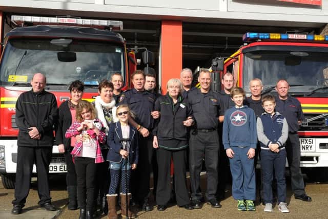 Texaco Co-op in Fareham donated Â£3,200 to Fareham fire station for the Fire Fighters Charity. Pictured are Co-op staff, fire station crew and families Picture: Paul Jacobs (160125-2)