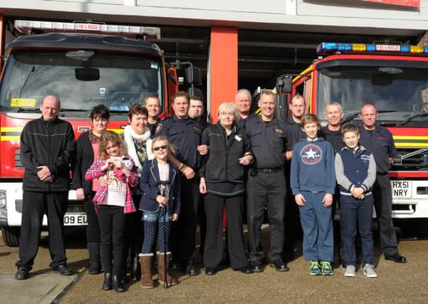 Texaco Co-op in Fareham donated Â£3,200 to Fareham fire station for the Fire Fighters Charity. Pictured are Co-op staff, fire station crew and families Picture: Paul Jacobs (160125-2)