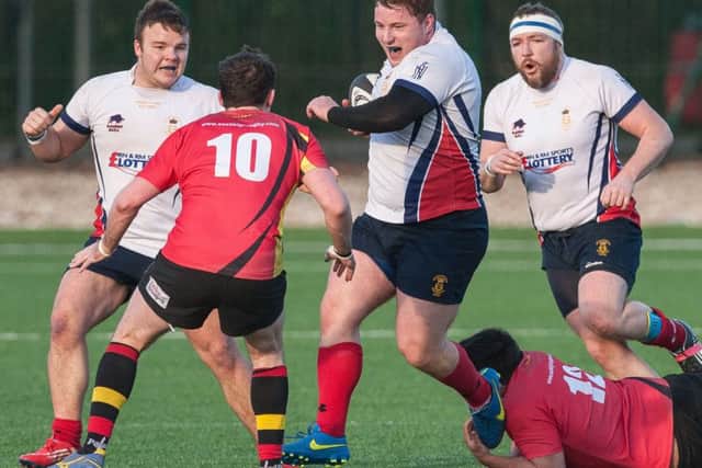 Will Rolfe, of Services, breaks through the Eastleigh line, assisted by Dougie Randall (left) and Phill Gilliland. Picture Keith Woodland