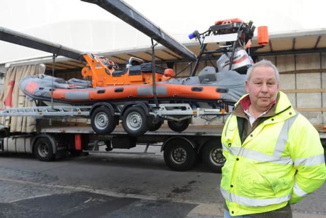 Steve Ayub, one of the directors at KB Boat Park at the Camber in Portsmouth, next to one of the two ex-RNLI Atlantic 75 RIBs which are being taken to Lesbos to be used to rescue refugees Picture: Sarah Standing (160152-9656)
