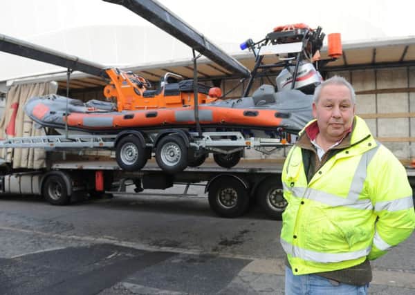Steve Ayub, one of the directors at KB Boat Park at the Camber in Portsmouth, next to one of the 

two ex-RNLI Atlantic 75 RIBs which are being taken to Lesbos to be used to rescue refugees Picture: Sarah Standing (160152-9656)