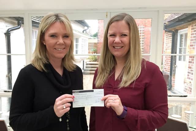 Melissa Reeve, Nicola Jane Operations Manager, hands over a cheque to Heidi Rehman, from Wessex Haven