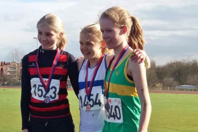 Josie Czura, centre, celebrates winning the gold medal