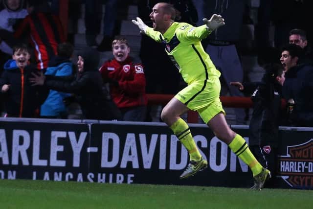 Morecambe keeper Barry Roche celebrates his goal against Pompey on Tuesday night Picture: Joe Pepler