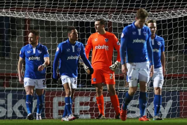 The Pompey players look dejected after Barry Roche's equaliser for Morecambe Picture: Joe Pepler