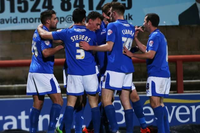 Gareth Evans, left, is congratualted by his team-mates after his first-half goal Picture: Joe Pepler