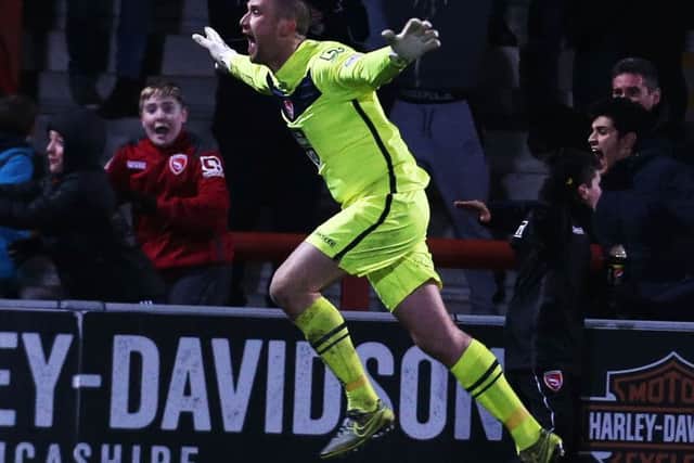 Morecambe keeper Barry Roche celebrates his late equaliser Picture: Joe Pepler