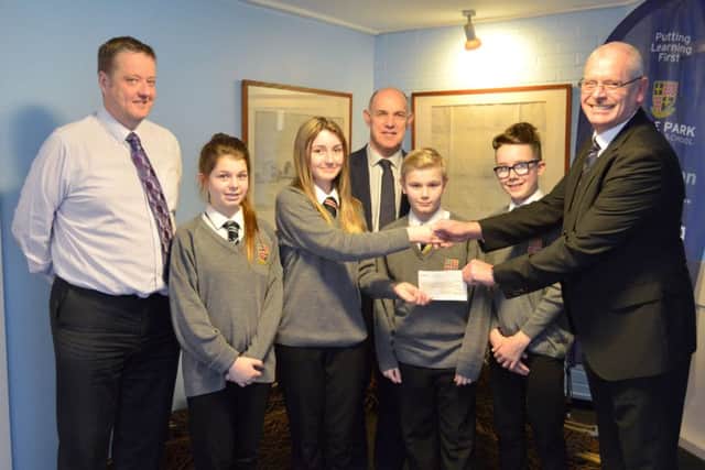 THANK YOU Year 8 student Paris-Jade Freeman receives the cheque from Andy Brockett, with students (from left) Katie Grimes, Callum Sturman and Ethan Hill. Far left is Richard Kelly, headteacher, with Stephen Shaw at the back