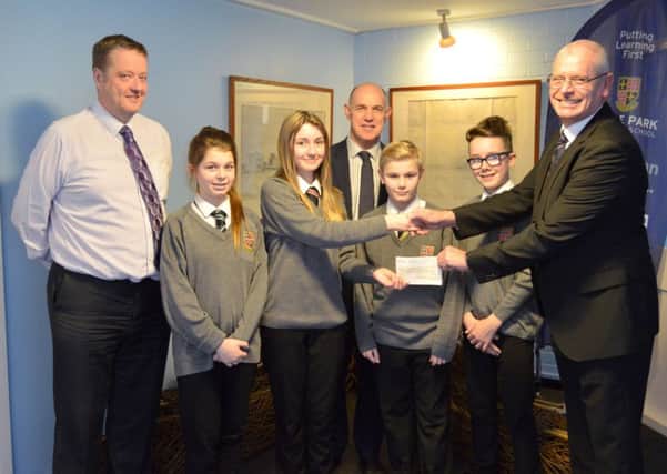 THANK YOU Year 8 student Paris-Jade Freeman receives the cheque from Andy Brockett, with students (from left) Katie Grimes, Callum Sturman and Ethan Hill. Far left is Richard Kelly, headteacher, with Stephen Shaw at the back