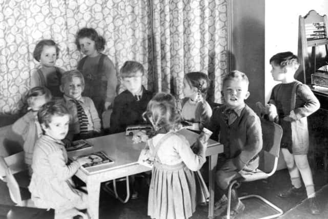 Something has captured the attention of the children here and judging by the bright light illuminating their faces, it might be a projector screen showing a cine film
