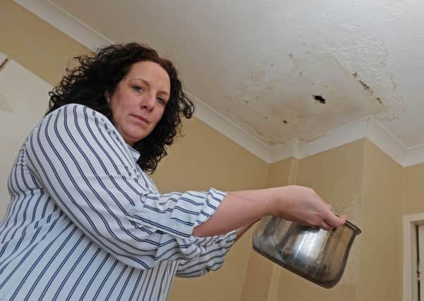 Navy wife Joanne Money with her dog Cookie who is in a running battle with the MoD over a water leak that is making life intolerable at her Gosport home
Picture Ian Hargreaves (160170-4)