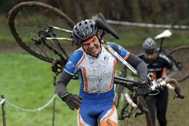 Fareham Wheelers rider James Brickell carries his bike through one of the tougher sections at Fairthorne Manor. Picture: Mick Young (151705-15)