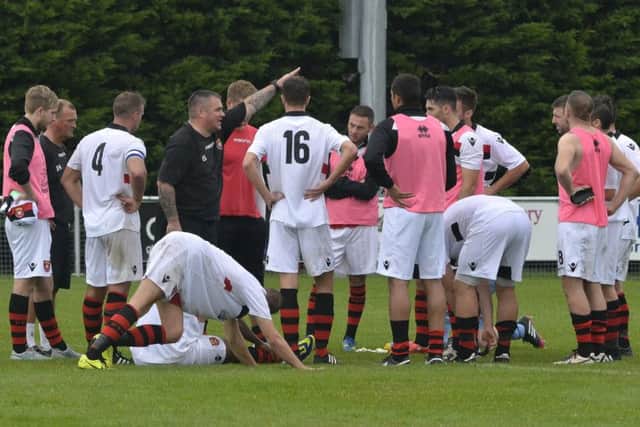 Petersfield Town boss Ian Saunders chats to his side Picture: Neil Marshall
