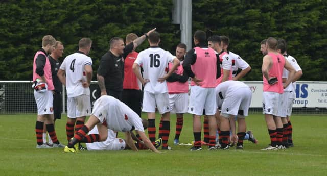 Petersfield Town boss Ian Saunders chats to his side Picture: Neil Marshall