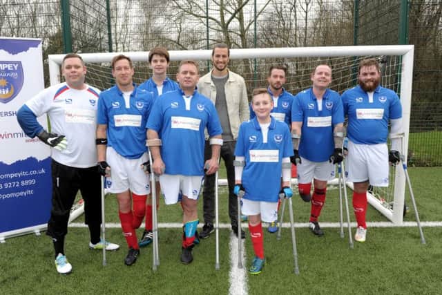 Portsmouth pose for a picture with Pompey defender Christian Burgess. From left: Robert Rice, Ray 'Spike' Westbrook, Michael Beel, Karl Ives, Che Gray, Roger Whitehouse, Chris Waller, TJ Yates. Picture: Paul Jacobs (160130-15)