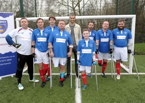 Portsmouth pose for a picture with Pompey defender Christian Burgess. From left: Robert Rice, Ray 'Spike' Westbrook, Michael Beel, Karl Ives, Che Gray, Roger Whitehouse, Chris Waller, TJ Yates. Picture: Paul Jacobs (160130-15)