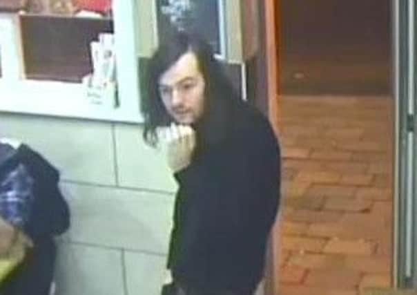 One of the men police want to speak to after the attack at Ken's Fried Chicken in Guildhall Walk