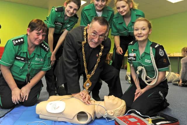 The Mayor of Gosport, Councillor Keith Farr learns CPR during a visit to the St John Ambulance headquarters in Gosport. From left, cadet manager Angie Petts, Isla Hadley, Kassia Gamble, Shannon Kikby, and Catherine Wright
Picture Ian Hargreaves (160172-2)