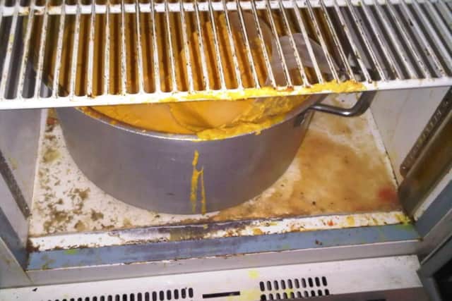 A pot of food stored in dirty conditions in rear store of Sarah Restaurant