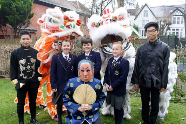 Lions and Laughing Buddha with St Johns pupils, from left, Harvey Cheng, Amelia Bayley, Callum Westcott, Lois Huntingdon and Sam Leung Picture: Francesca Williams