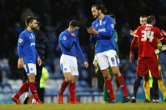 Pompey players can't hide their disappointment at the final whistle. Picture: Joe Pepler