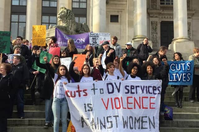 Protesters on the steps of the Guildhall to oppose council cuts to domestic abuse services