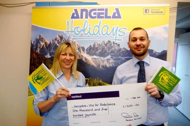 Angela Holidays managing director Paula Roe presenting a cheque for £1500 to Ray Southam, Hants & IOW Air Ambulance corporate & community fundraiser
