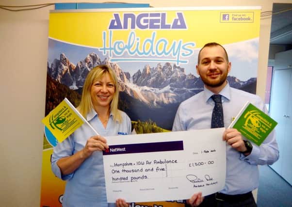 Angela Holidays managing director Paula Roe presenting a cheque for Â£1500 to Ray Southam, Hants & IOW Air Ambulance corporate & community fundraiser