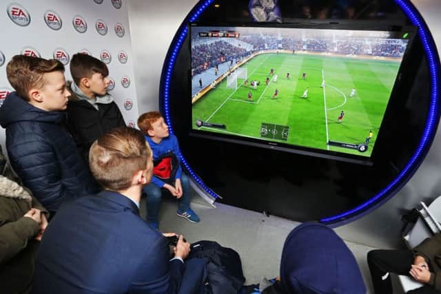 Young Pompey fans play EA Sports Fifa 16 at Fratton Park. Picture: Joe Pepler