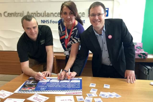 Will Hancock, right, signs the Time to Change Pledge on behalf of South Central Ambulance Service NHS Foundation Trust, of which he is chief executive