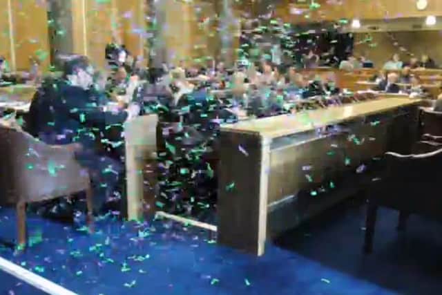 Sisters Uncut released 4,745 pieces of green and purple confetti into the council chamber, halting the budget meeting for 10 minutes
